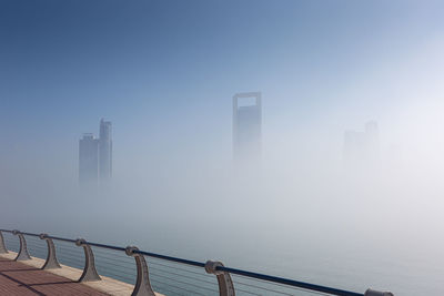 Scenic view of sea by buildings against sky