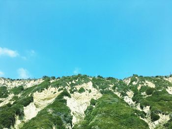 Low angle view of mountain against clear blue sky