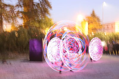 Close-up of bubbles against illuminated trees