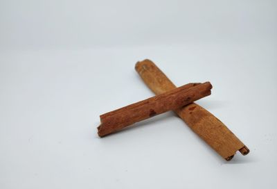 Close-up of broken coffee beans against white background