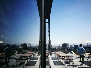 Man in city against sky