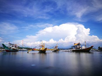 Commercial dock by sea against sky