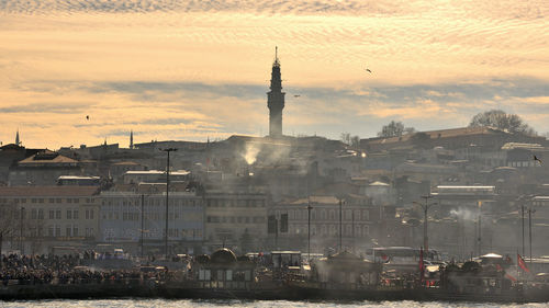 Buildings in city at sunset