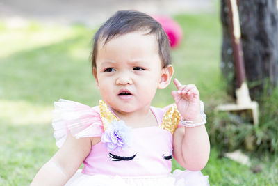 Portrait of cute girl sitting outdoors