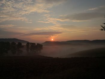 Scenic view of field against sky during sunset