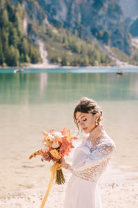 Beautiful woman standing by lake