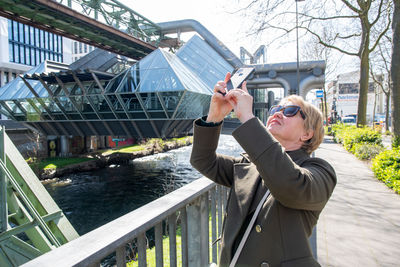 Middle-aged woman making a report of the wuppertal suspension railway train