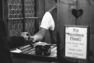 Midsection of man paying money at restaurant