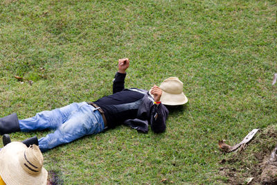 High angle view of man lying on grass