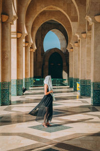 Low angle view of woman standing against building