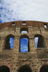Low angle view of historical building against cloudy sky