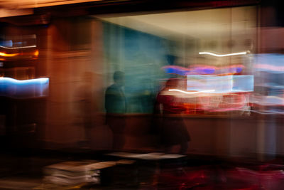 Blurred motion of people and light trails at night