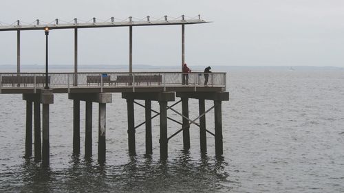 Pier over sea against clear sky