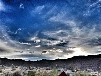 Scenic view of mountains against cloudy sky