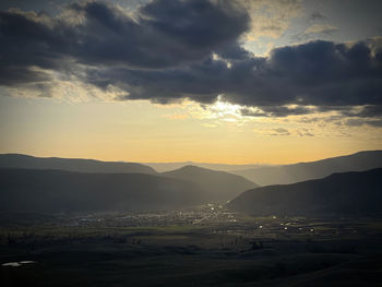 Scenic view of silhouette mountains against sky during sunset