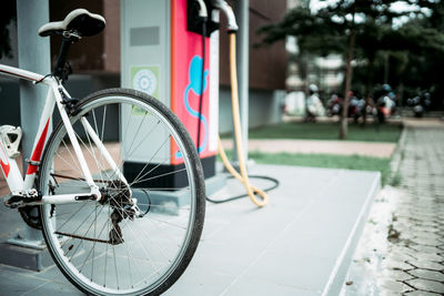 Close-up of bicycle on sidewalk