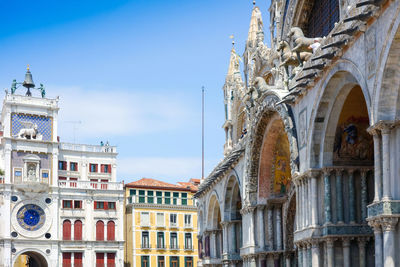 Low angle view of st mark clock tower against sky in city