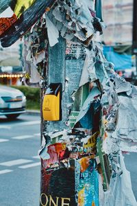 Torn posters on pole in city