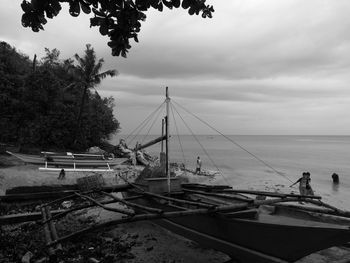 Boats moored on sea against sky