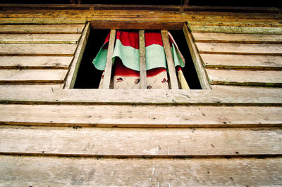 Low angle view of clothes drying against window