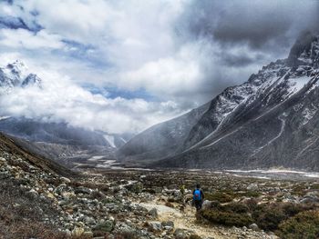 Rear view of man with mountain range against sky, nepal, ebc track