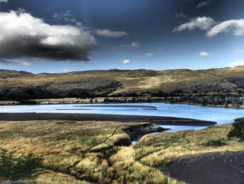 Calm lake along rocky landscape