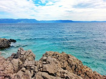 Scenic view of sea against cloudy sky