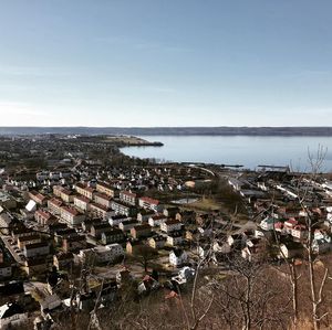 High angle view of townscape by sea against sky