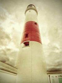 Low angle view of tower against cloudy sky