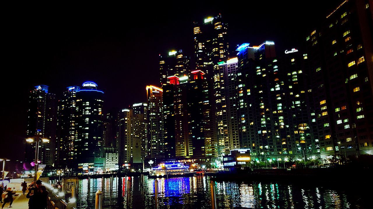 illuminated, night, city, sky, multi colored, lighting equipment, building exterior, no people, outdoors, low angle view, architecture, skyscraper, christmas lights, tree, cityscape, urban skyline, nature