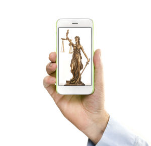 Close-up of hand holding smart phone over white background