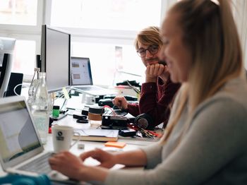 Side view of woman using laptop