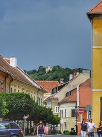 Buildings in city against blue sky