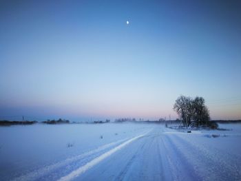 Scenic view of snow covered field against clear sky