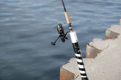 High angle view of fishing rod by sea