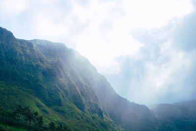 Scenic view of mountains against cloudy sky