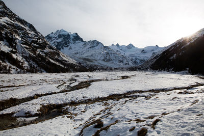 Scenic view of mountains against sky during winter