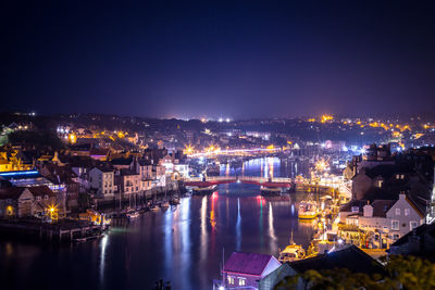 High angle view of illuminated city buildings at night