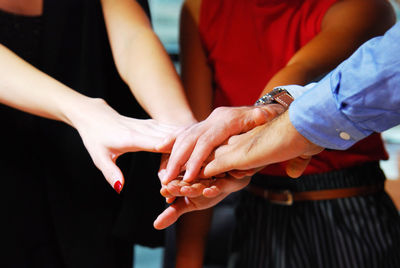 Midsection of couple holding hands