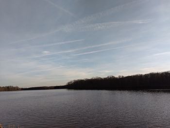 Scenic view of lake against sky at sunset