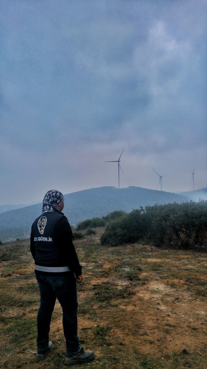 wind turbine, turbine, environment, renewable energy, alternative energy, environmental conservation, wind power, sky, fuel and power generation, full length, real people, nature, landscape, one person, men, technology, rear view, lifestyles, field, land, outdoors