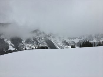 Snow covered landscape against sky