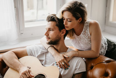 Young couple sitting at home