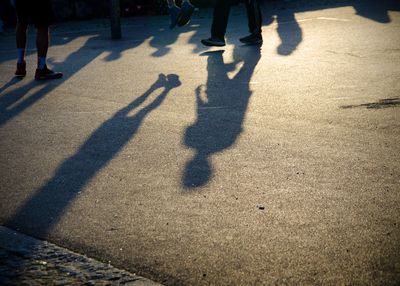 Low section of people standing on tiled floor