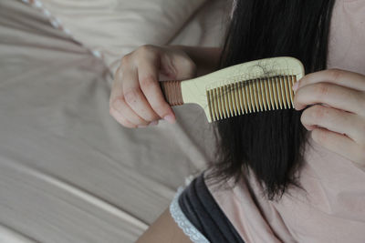 Closeup of comb brush with long loss hair with copy space. healthcare concept. selective focus.