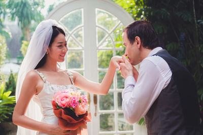 Newlywed couple embracing outdoors