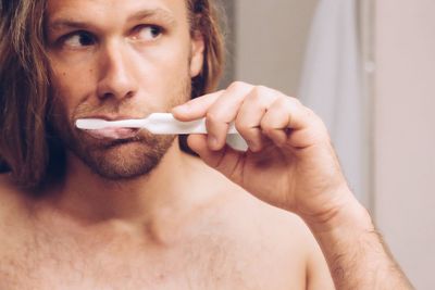 Portrait of man brushing teeth