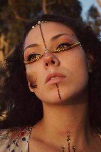 Close-up of woman with make-up looking away