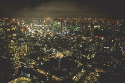 High angle view of illuminated city buildings at night