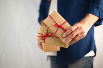 Close-up of man holding umbrella standing in box